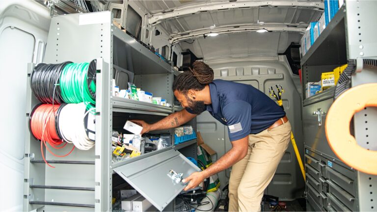 SALT Service Co. technician preparing tools in service van for tankless water heater installation in Austin, TX.