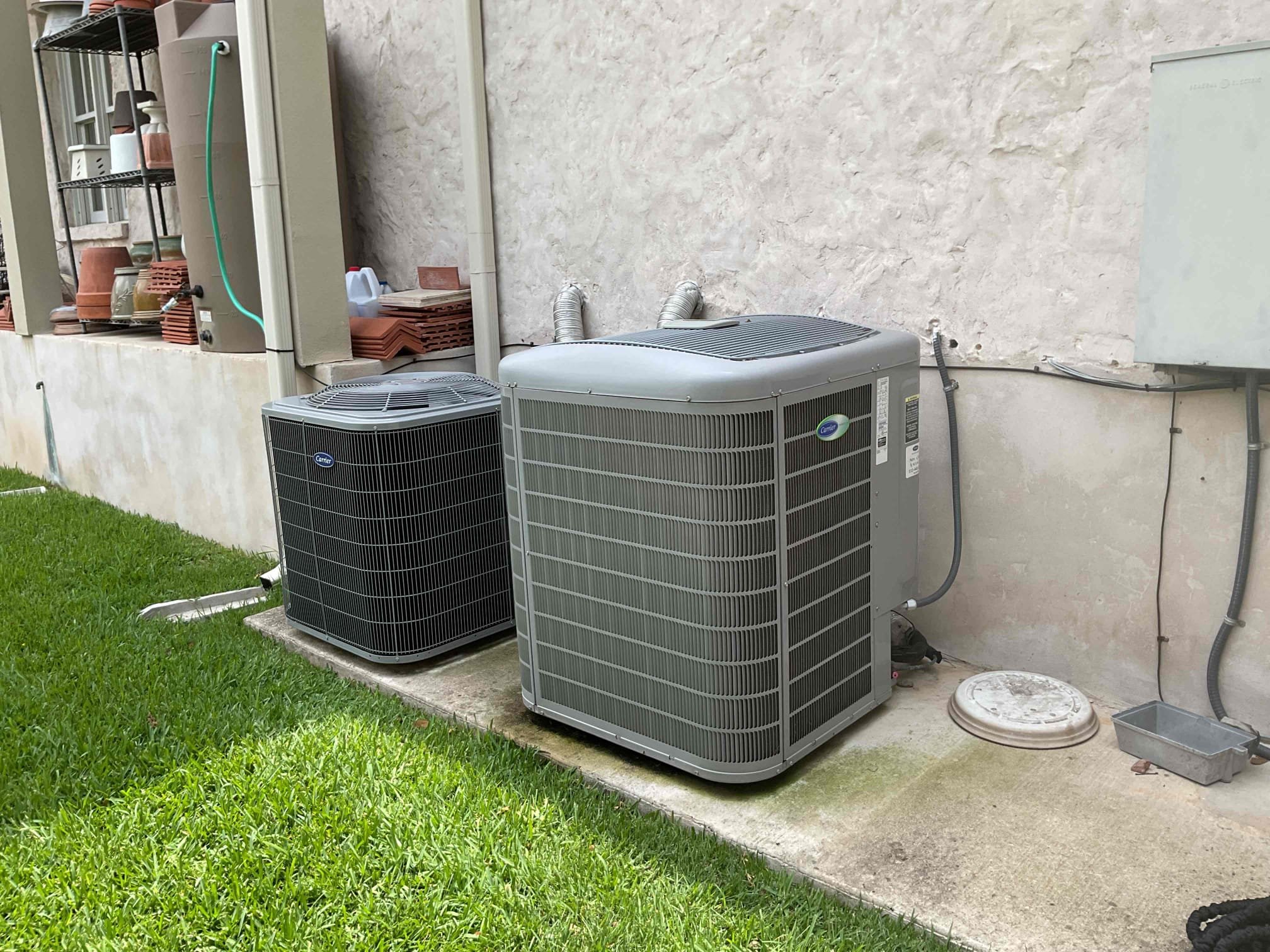 Two newly installed HVAC units outside a home