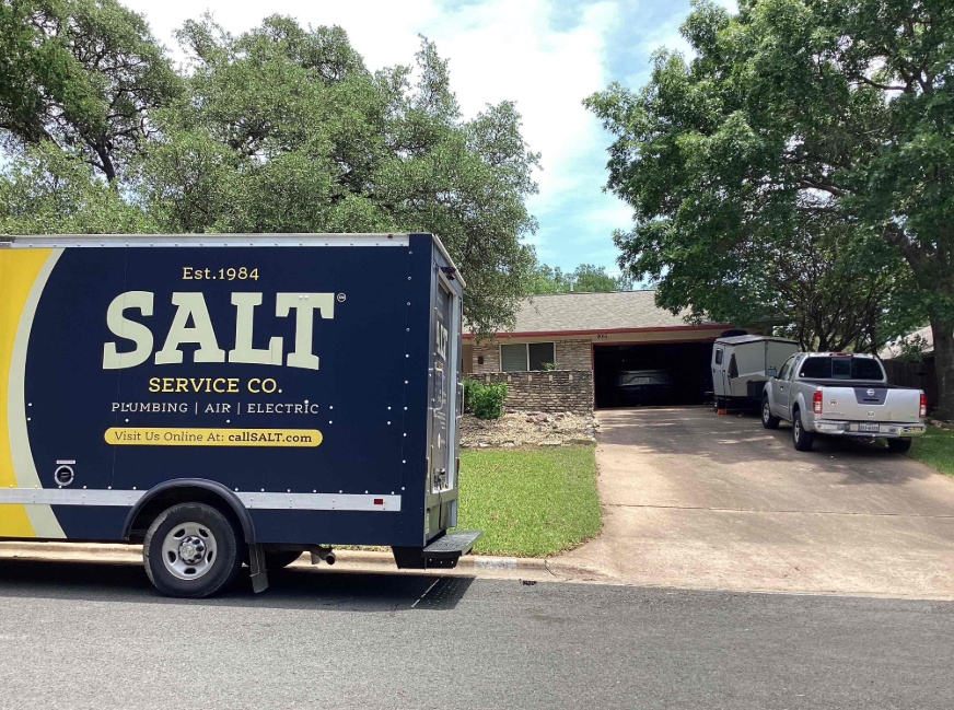 SALT Service Co. plumbing, air, and electric service truck parked outside a home for a residential repair or maintenance appointment
